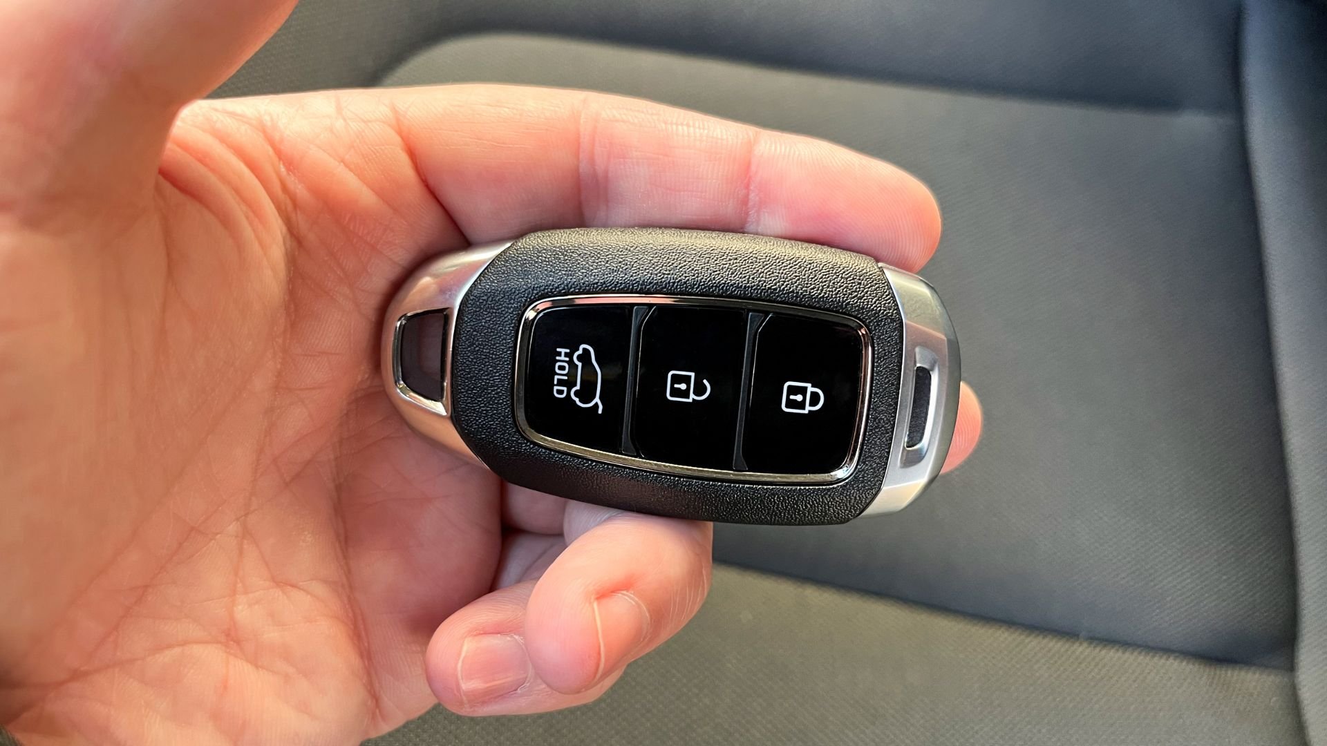 Modern car key fob with lock, unlock, and trunk release buttons